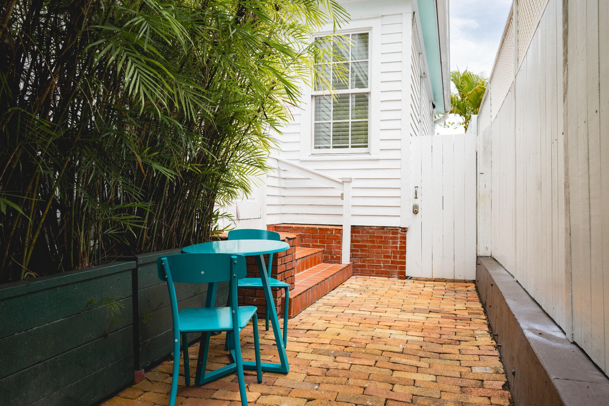 The Bartlum private courtyard with a turquoise table and chairs